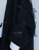 Black coat with floral patterns on a white background