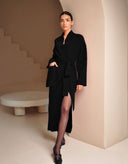 Woman wearing Sophia black wrap cardigan and maxi skirt matching set by Aina Gasse