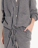 Gray knitted cardigan and pants set on a plain background