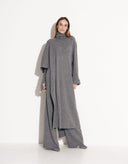 Woman modeling Valencia gray wool poncho and matching pants set by Aina Gasse