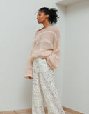 Woman wearing the Antonia pink handmade mohair sweater with sequins by Aina Gasse