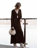 Full-length view of women’s chocolate brown long-sleeve fitted knit midi dress