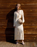 Full-length view of elegant vanilla long-sleeve knit midi dress for women