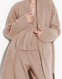 Close-up of soft beige wool-blend knit texture on Aria designer cardigan