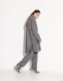 Woman wearing an elegant gray oversized knit cardigan with matching gray pants