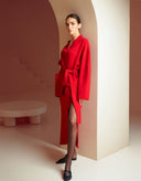 Woman modeling Sophia red wrap cardigan and matching maxi skirt set by Aina Gasse.