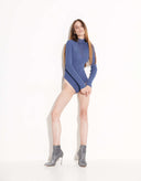 Full-length view of women’s blue fitted knit bodysuit with long raglan sleeves