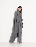 Side view of Valencia gray asymmetrical poncho and coordinated tailored pants