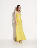 Side view of elegant yellow sleeveless summer maxi dress by Aina Gasse